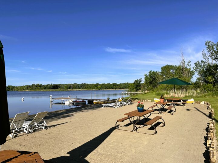 Swan Lake Resort & Campground - sandy beach with picnic tables